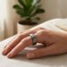 Close-up of a sleek smart ring worn on a finger during a morning workout.