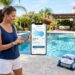 Sleek robotic pool cleaner scrubbing the blue tiled floor of a swimming pool.